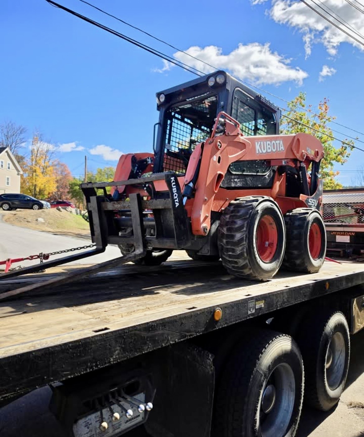 Kubota skid steer loaded on a flatbed truck